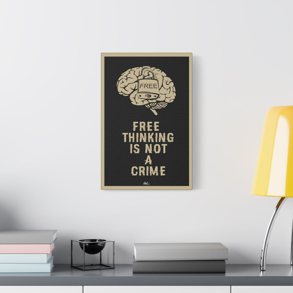 Free Thinking Is Not a Crime canvas beside a yellow desk lamp, locked brain with a padlock stamped Free, beige on charcoal