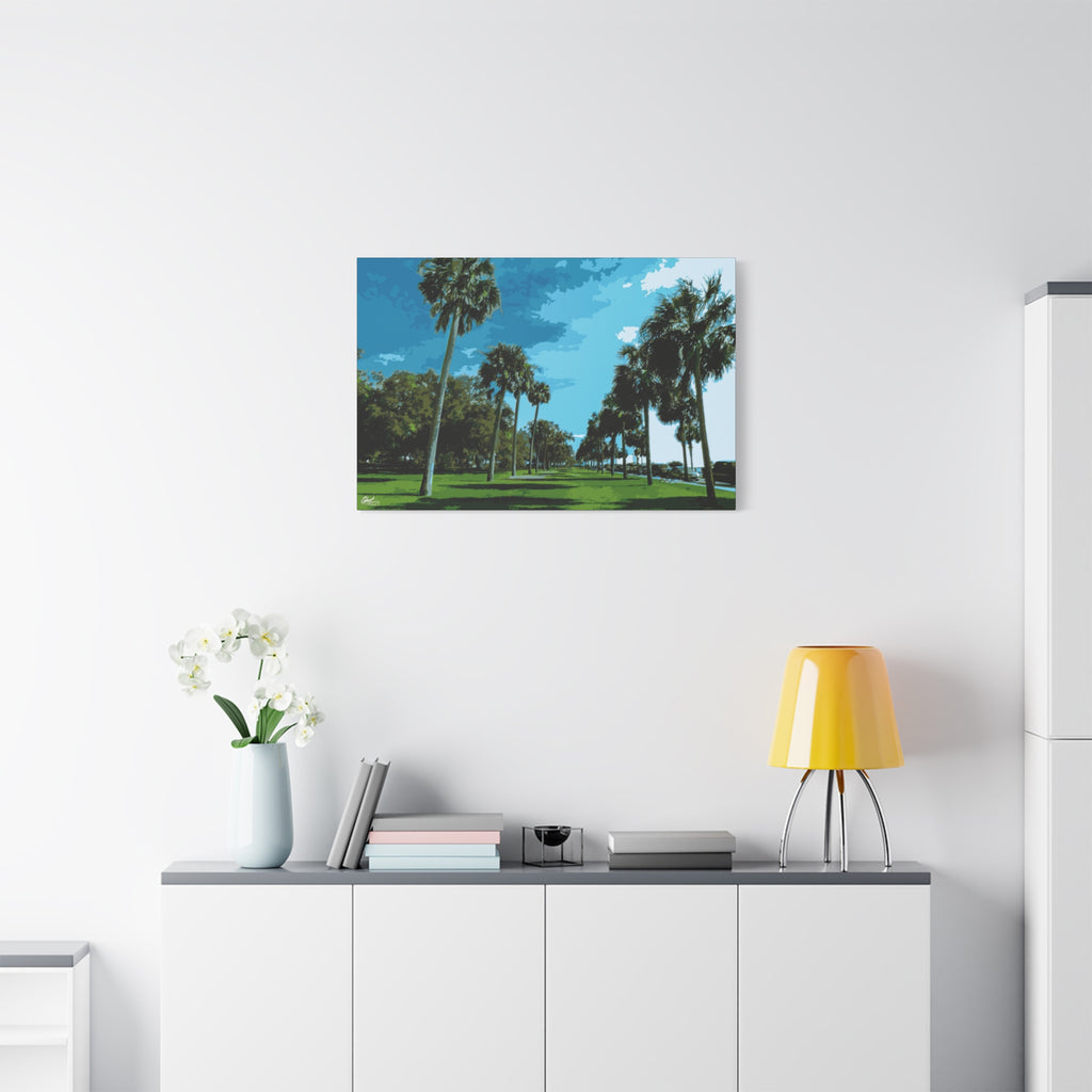 The Battery (Original) canvas above a white sideboard and yellow lamp, tall palms, green lawns and blue sky at the Battery