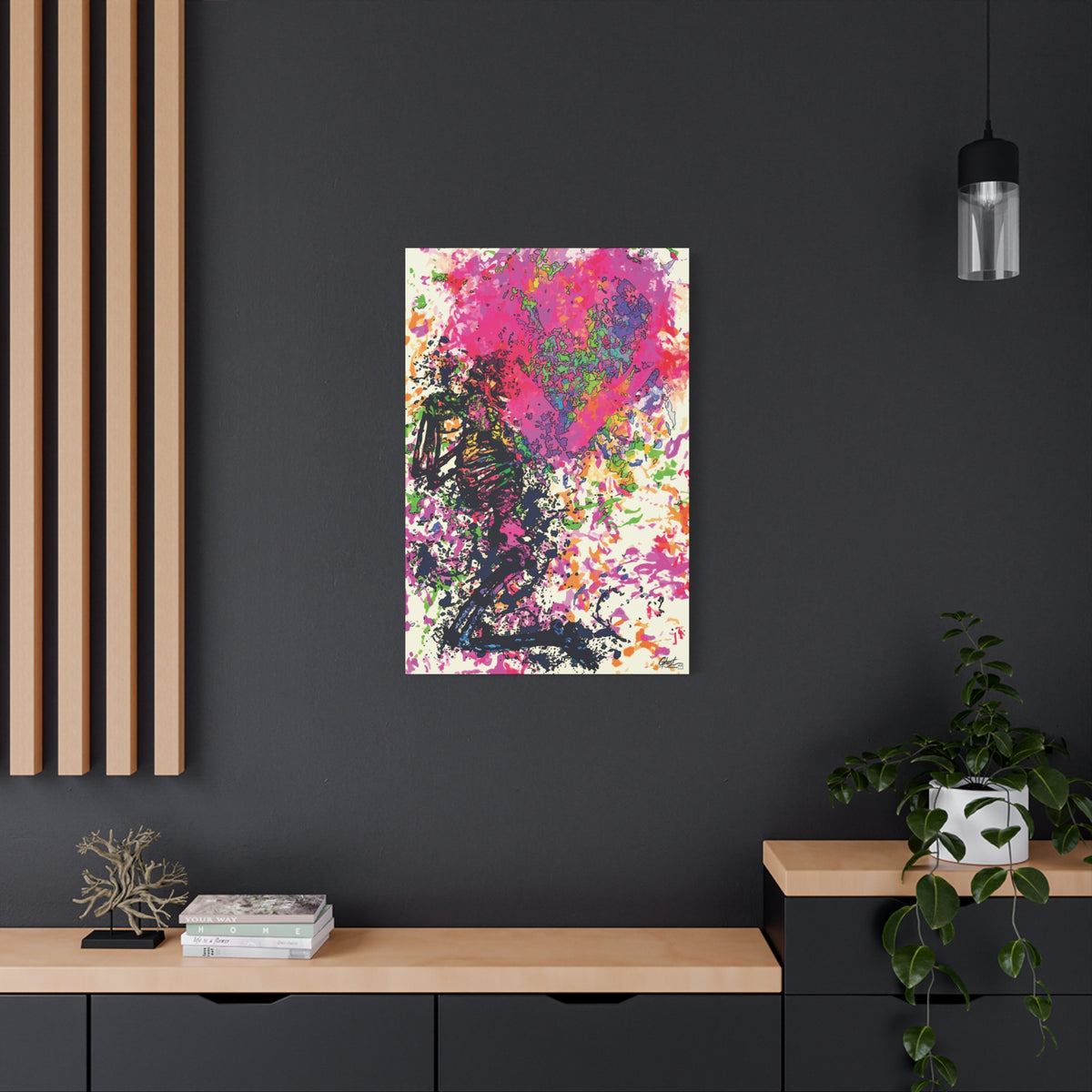 Waiting on My Love large canvas on a charcoal wall over an oak shelf, kneeling skeletal figure under a fuchsia splatter heart