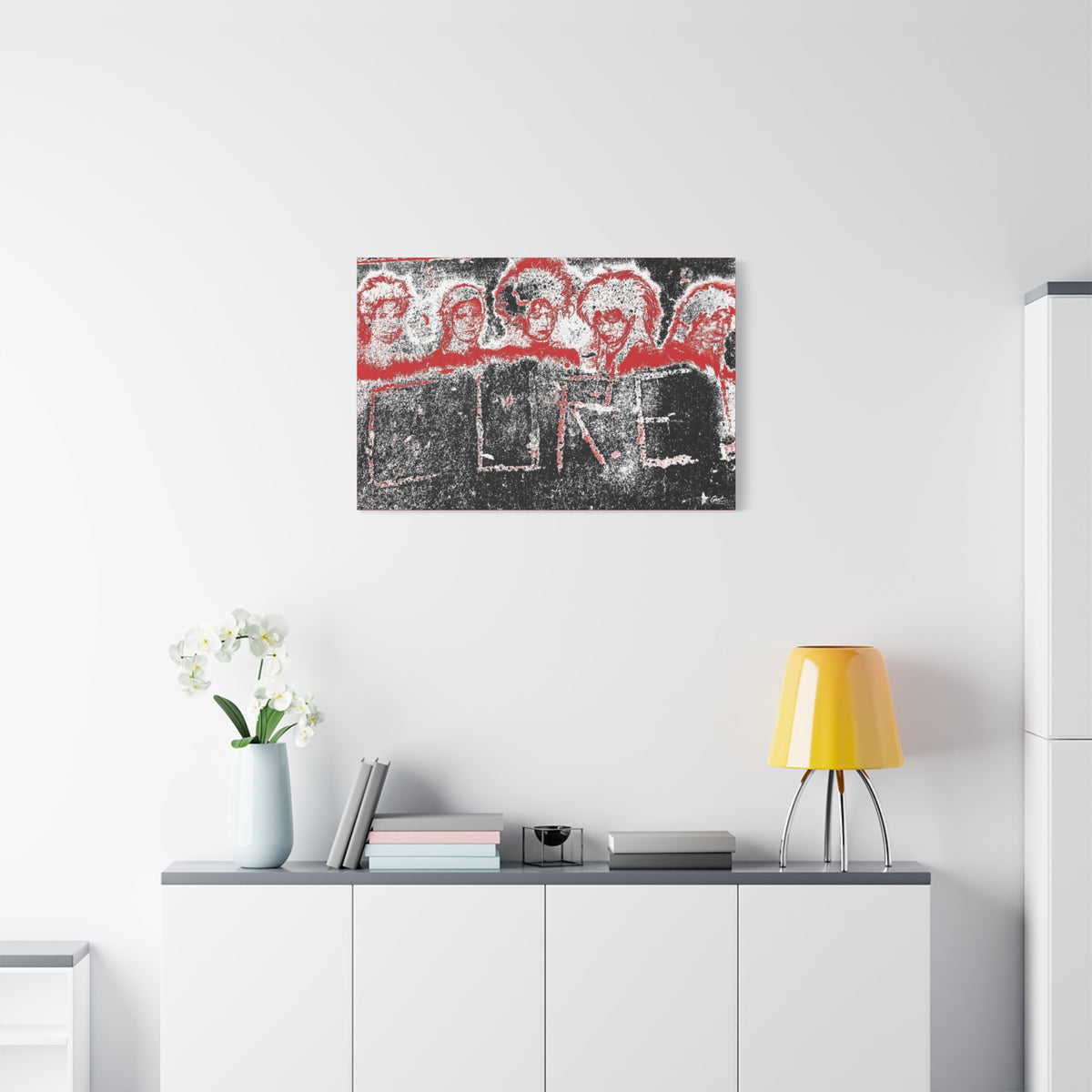 Lowcountry Medicine medium canvas above a white sideboard and yellow lamp, red-outlined faces over engraved lettering in a grungy sidewalk