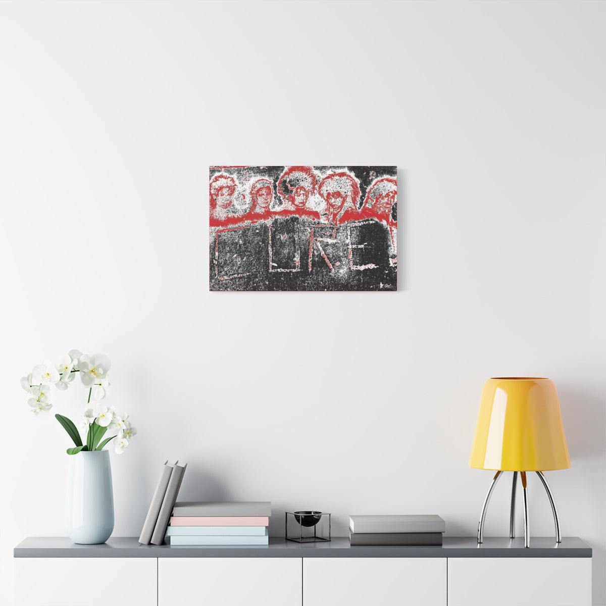 Lowcountry Medicine medium canvas over a console with white flowers, red-outlined faces over engraved lettering in a grungy sidewalk