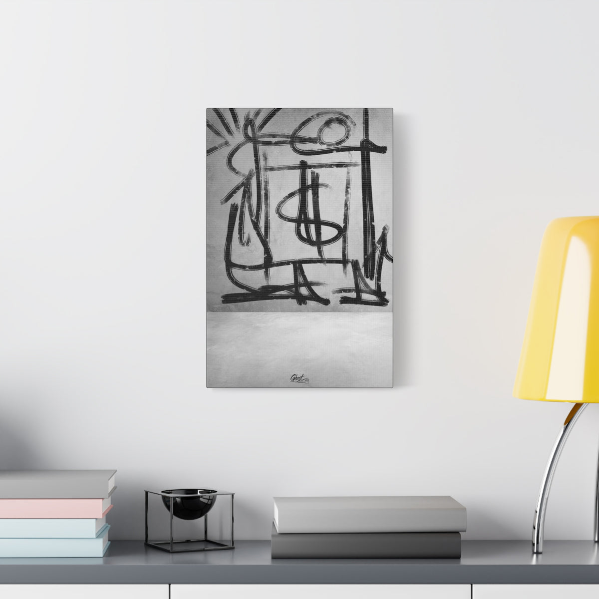 Best Day Ever small canvas beside a yellow desk lamp, bold charcoal strokes tracing playful abstract shapes