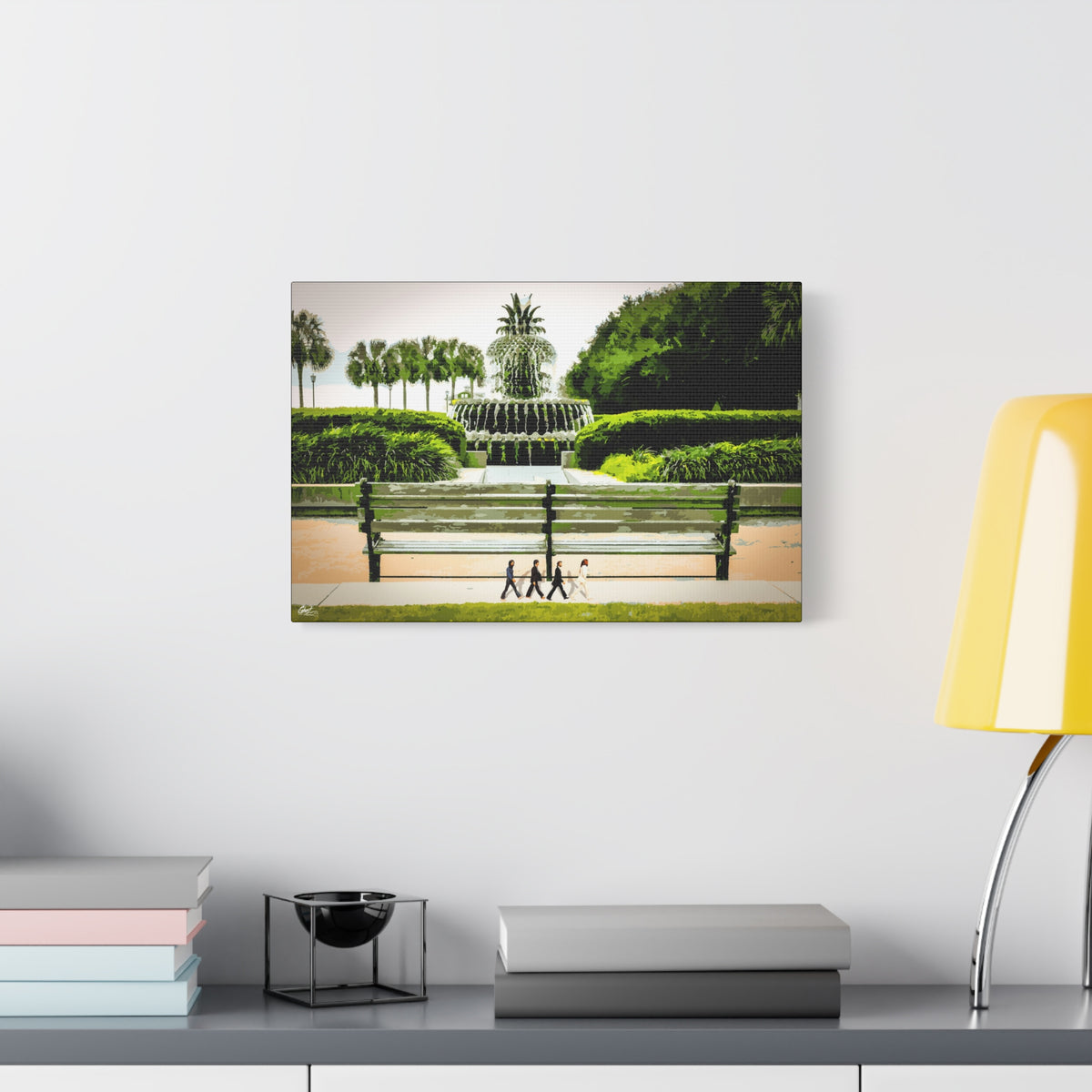 Pineapple Crossing canvas beside a yellow desk lamp, Pineapple Fountain with palmettos, hedges and four walkers