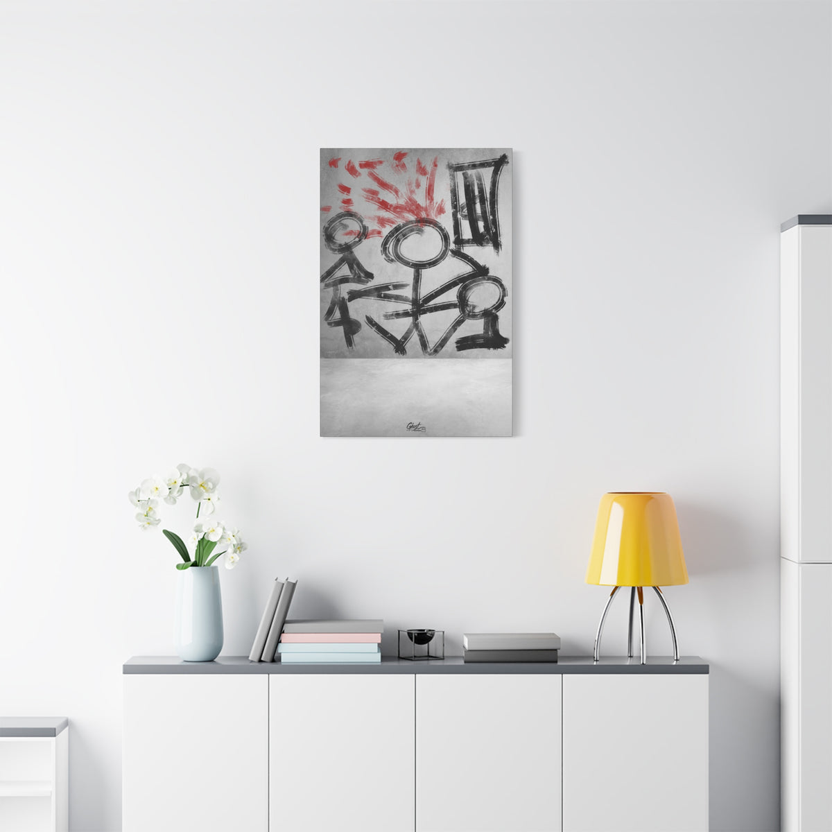 Stressed Out small canvas above a white sideboard and yellow lamp, black stick figures beneath red brushstroke rays