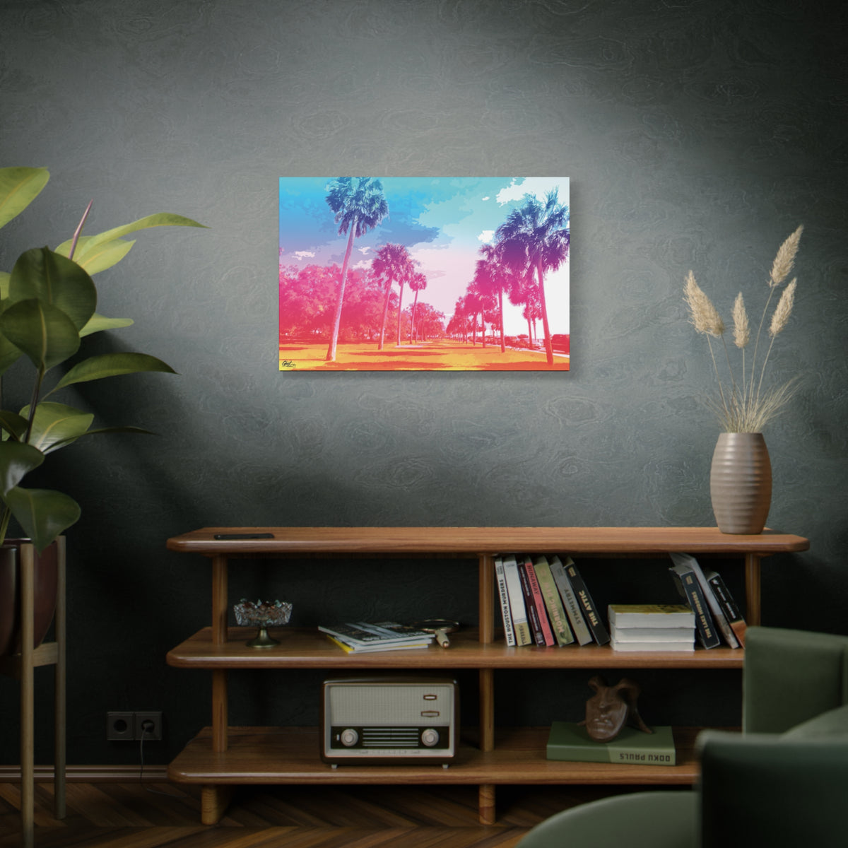 The Battery Tropical Edition large canvas above a wooden bookshelf, retro palms glowing in a dreamy pink and turquoise sunset