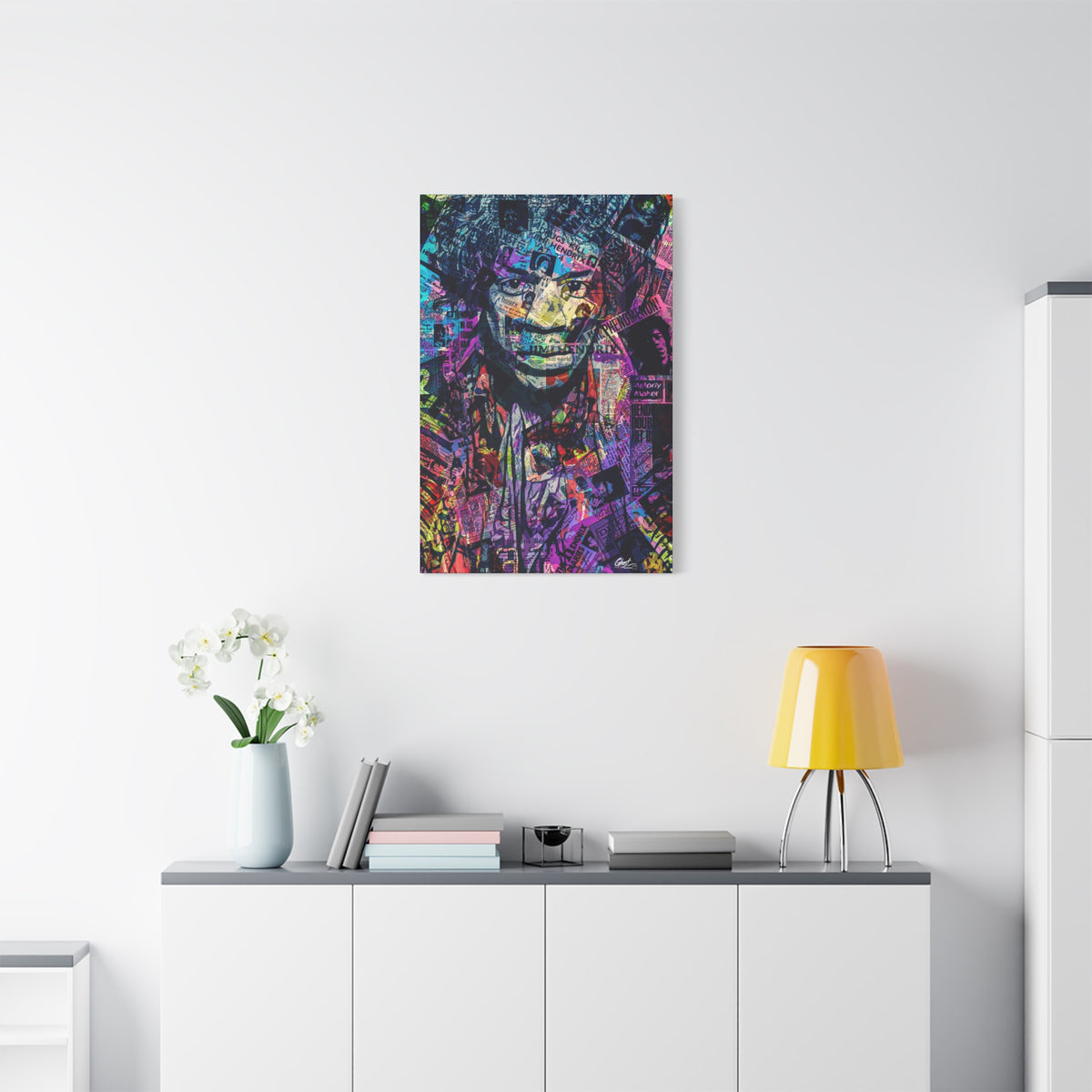 Purple Voodoo small canvas above a white sideboard and yellow lamp, haloed face in a blue, purple and pink newspaper collage