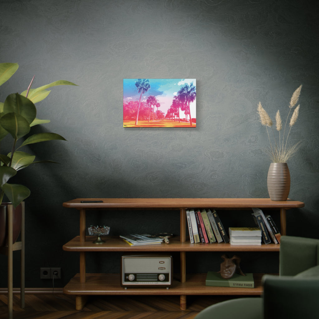 The Battery Tropical Edition small canvas above a wooden bookshelf, retro palms glowing in a dreamy pink and turquoise sunset
