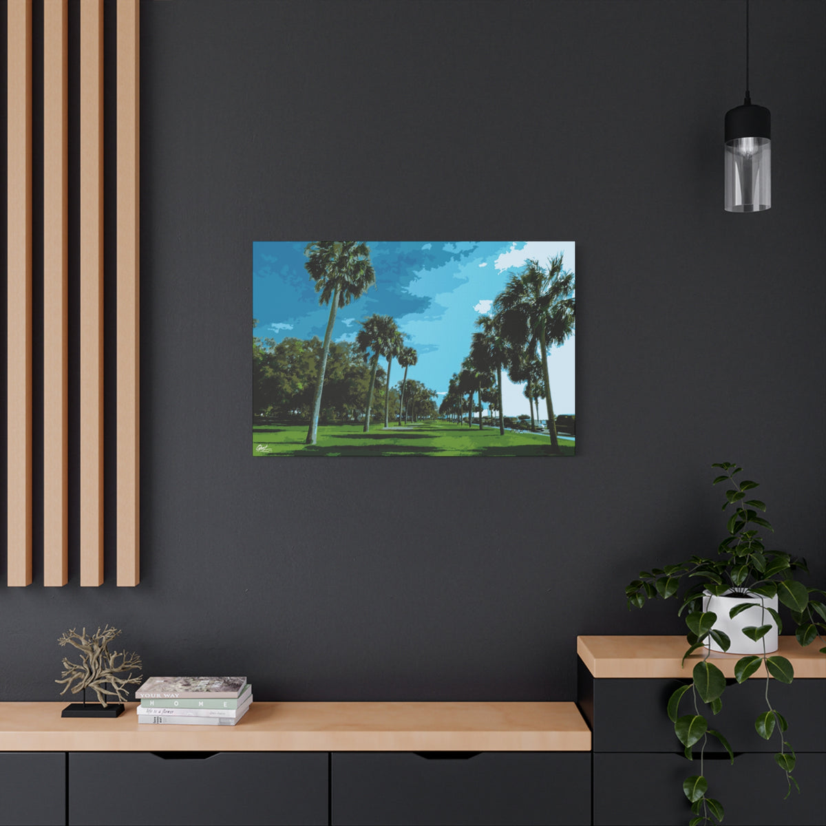 The Battery (Original) medium canvas on a charcoal wall by wood slats, tall palms, green lawns and blue sky at the Battery