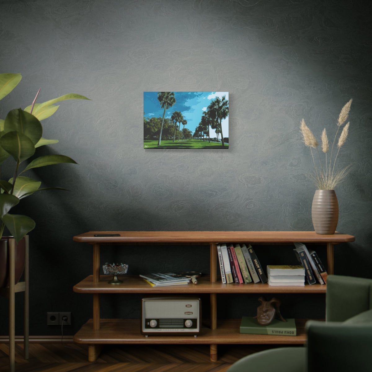The Battery (Original) small canvas on a green-gray wall over bookshelves, sunlit palms and long shadows by the water