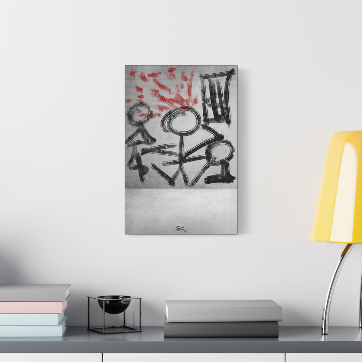 Stressed Out small canvas beside a yellow desk lamp, black stick figures beneath red brushstroke rays