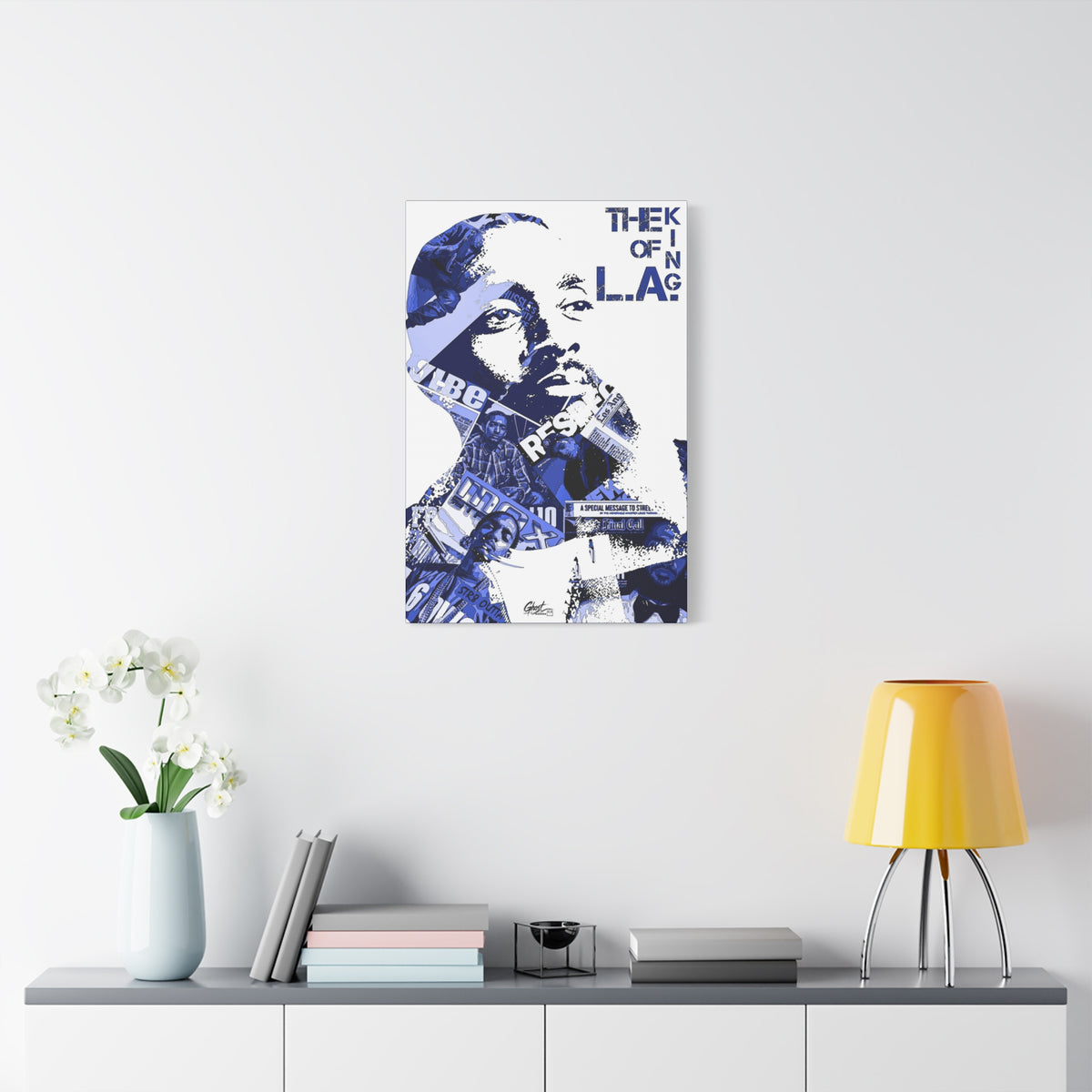 Crown of the Coast medium canvas on a white wall above a console, blue collage portrait on white with bold text