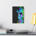 Stalk at Night, Prism Edition canvas beside a yellow desk lamp, pale mask built from neon blue, violet and green shards