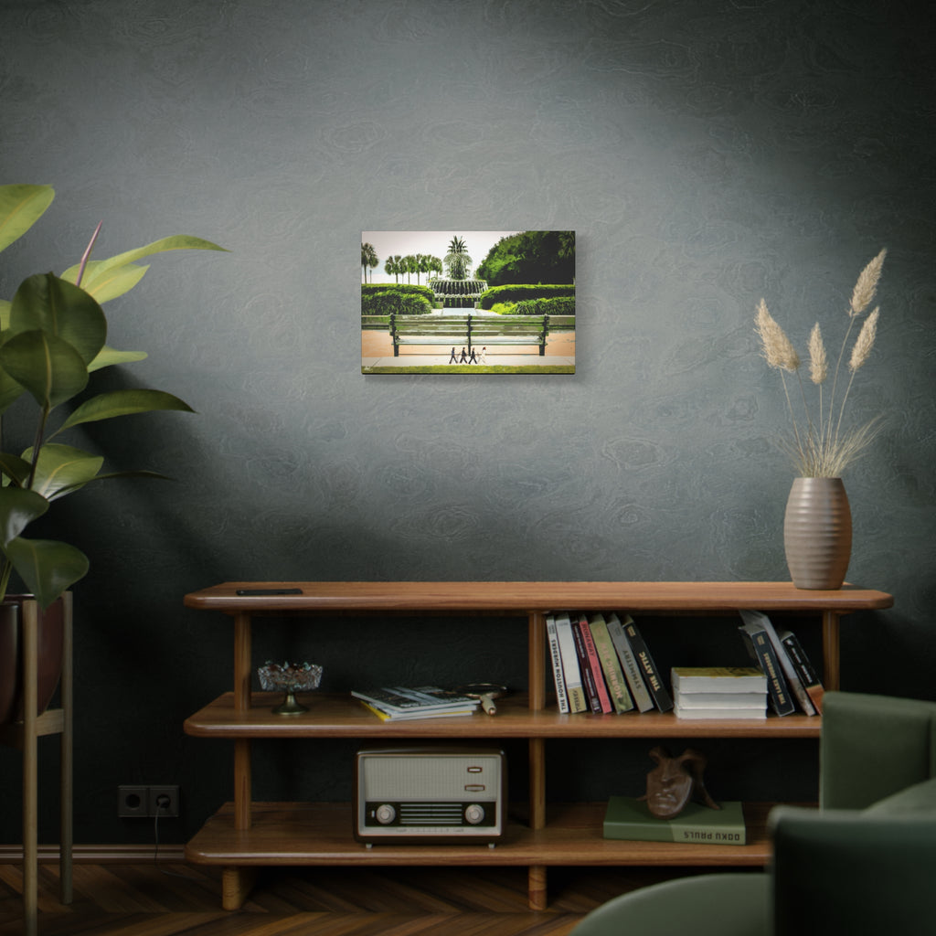 Pineapple Crossing canvas on a green-gray wall over bookshelves, painterly park scene with the pineapple fountain