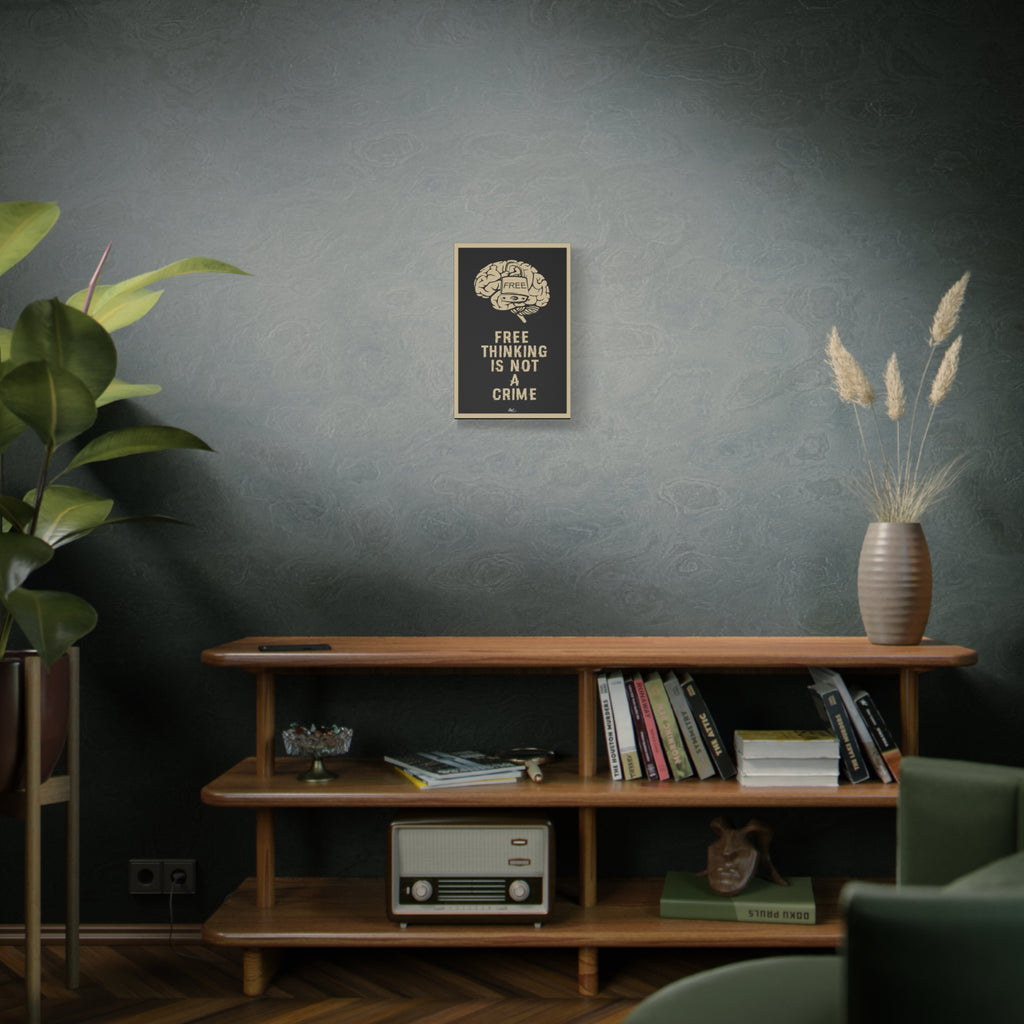 Free Thinking Is Not a Crime small canvas on a green-gray wall over bookshelves, padlocked brain in beige on charcoal