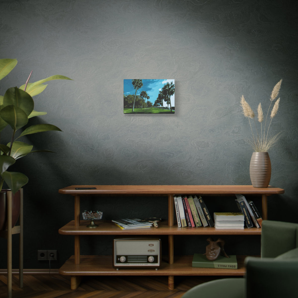 The Battery (Original) small canvas above a wooden bookshelf, tall palms, green lawns and blue sky at the Battery
