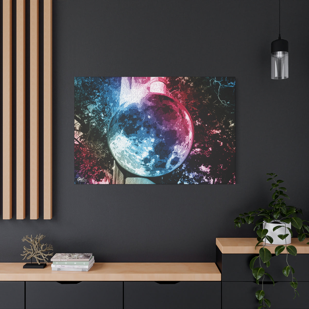 Universe in a Mirror large canvas on a charcoal wall by wood slats, glowing mirrored orb floating in a dreamy pink-blue sky