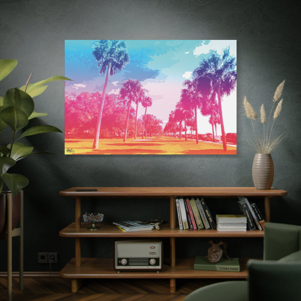 The Battery Tropical Edition canvas above a wooden bookshelf, palm silhouettes against a turquoise, pink and gold sunset