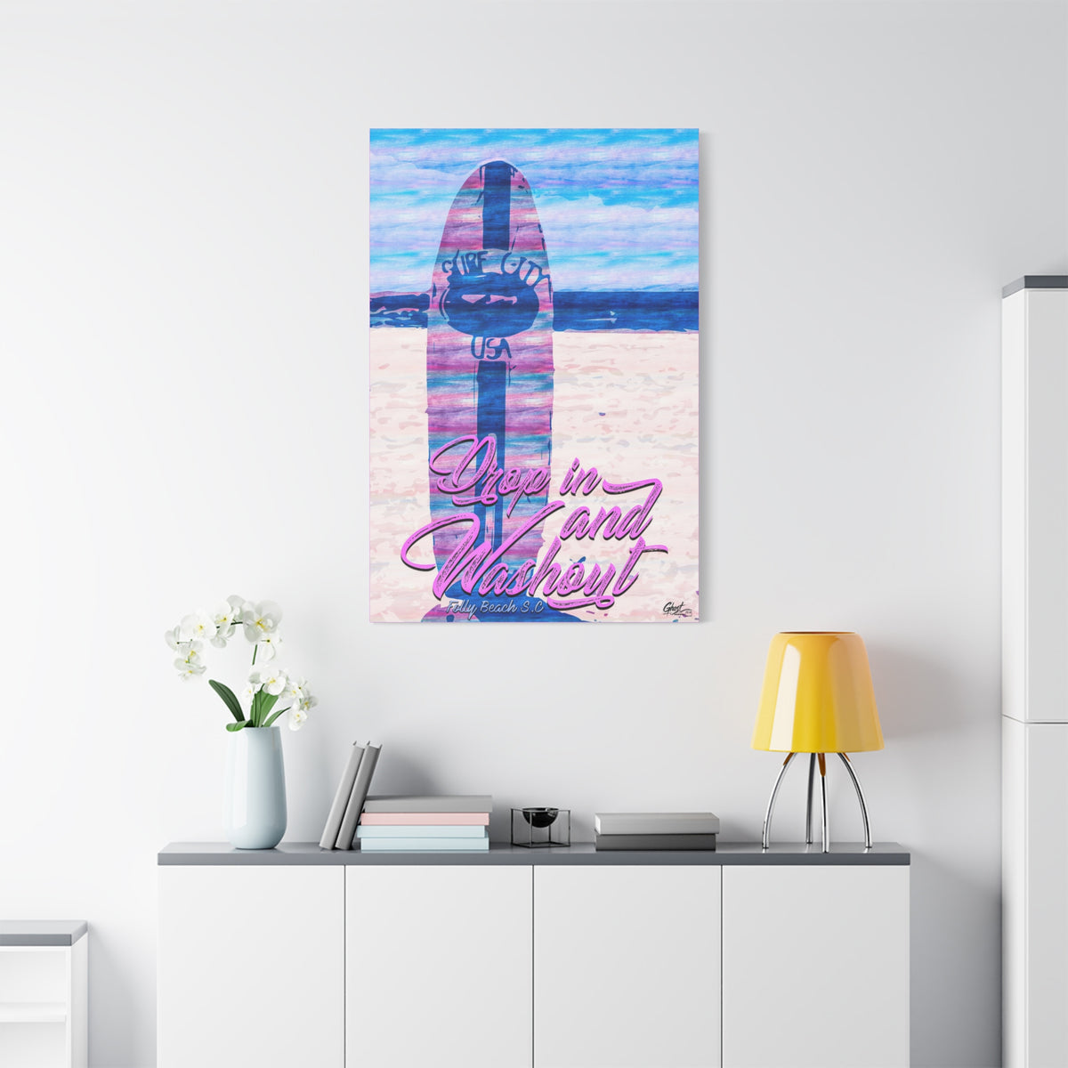 Drop In and Wash Out, Folly Beach medium canvas on a white wall over a sideboard, pastel surfboard with script lettering
