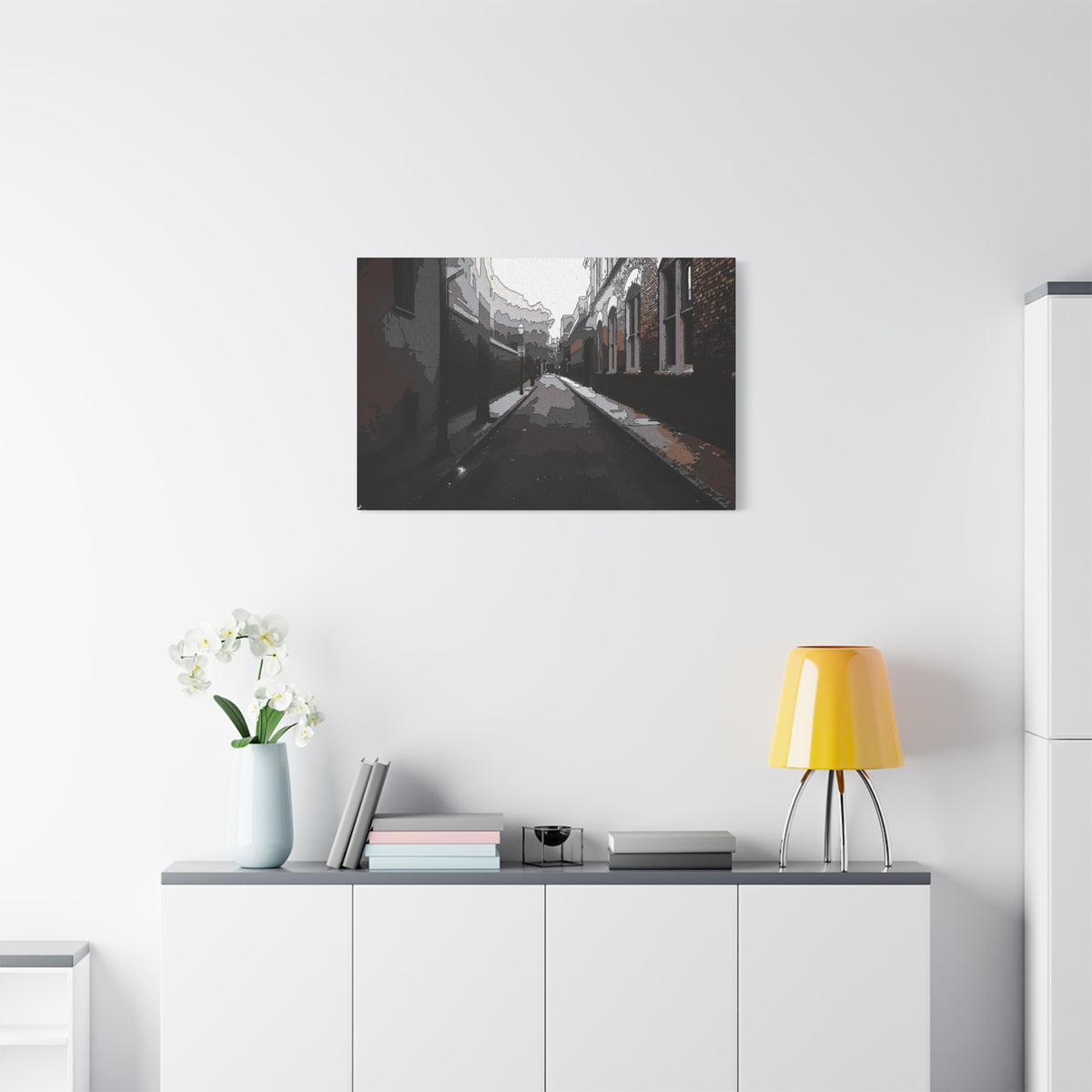 Charleston One Way medium canvas above a white sideboard and yellow lamp, moody alley with old brick walls and long shadows