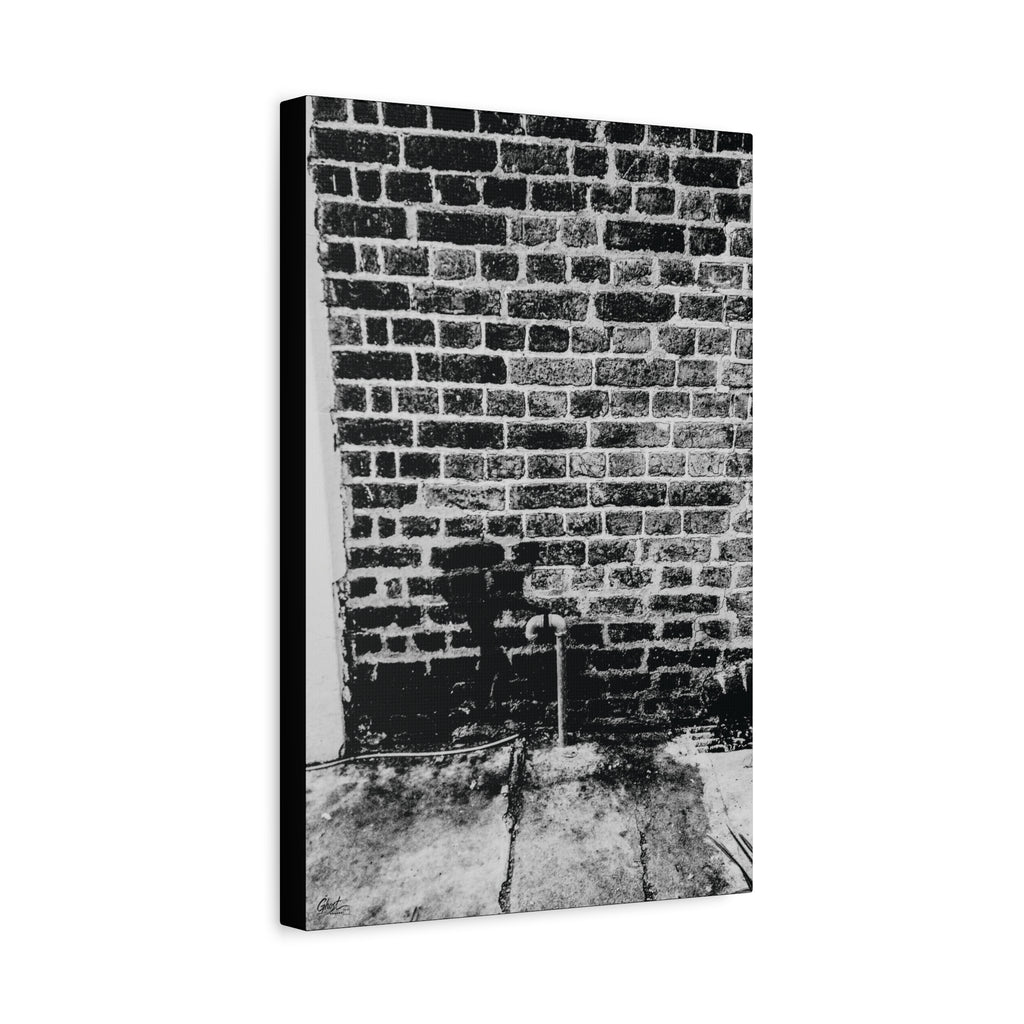 A Little Hiking in Charleston canvas, angled side view: stenciled hiker on a weathered brick wall in black and white