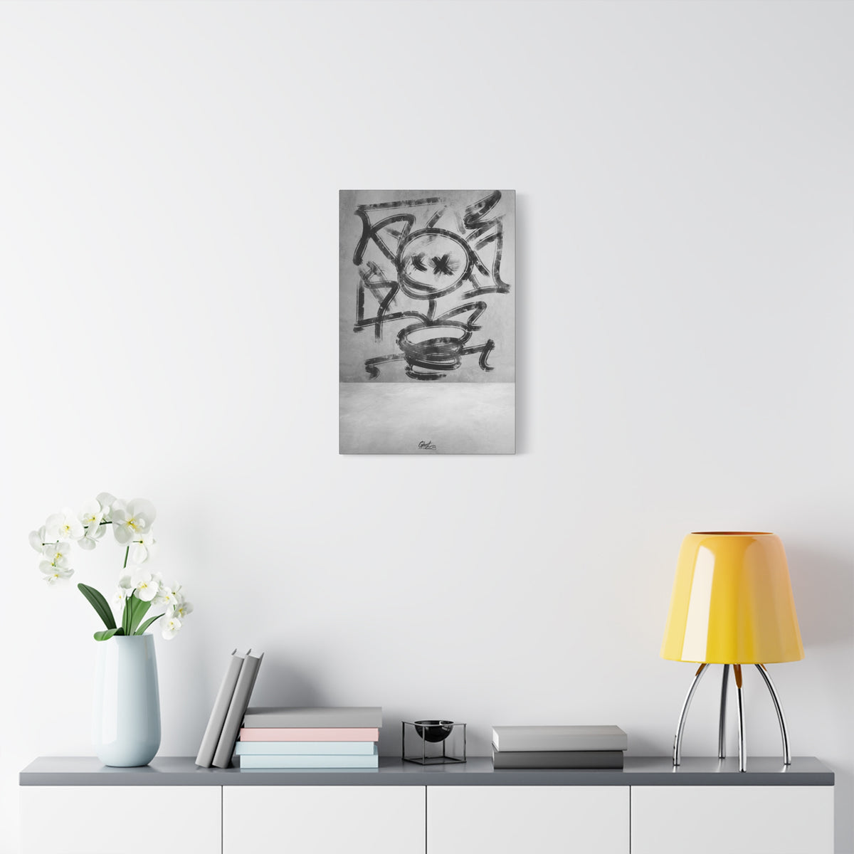 Going Crazy small canvas over a console with white flowers, loose black marks circling a central form above a small cup shape