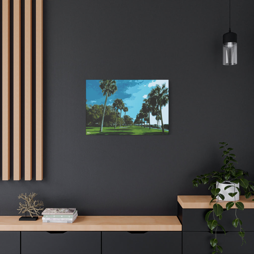 The Battery (Original) canvas on a charcoal wall over an oak shelf, tall palms, green lawns and blue sky at the Battery