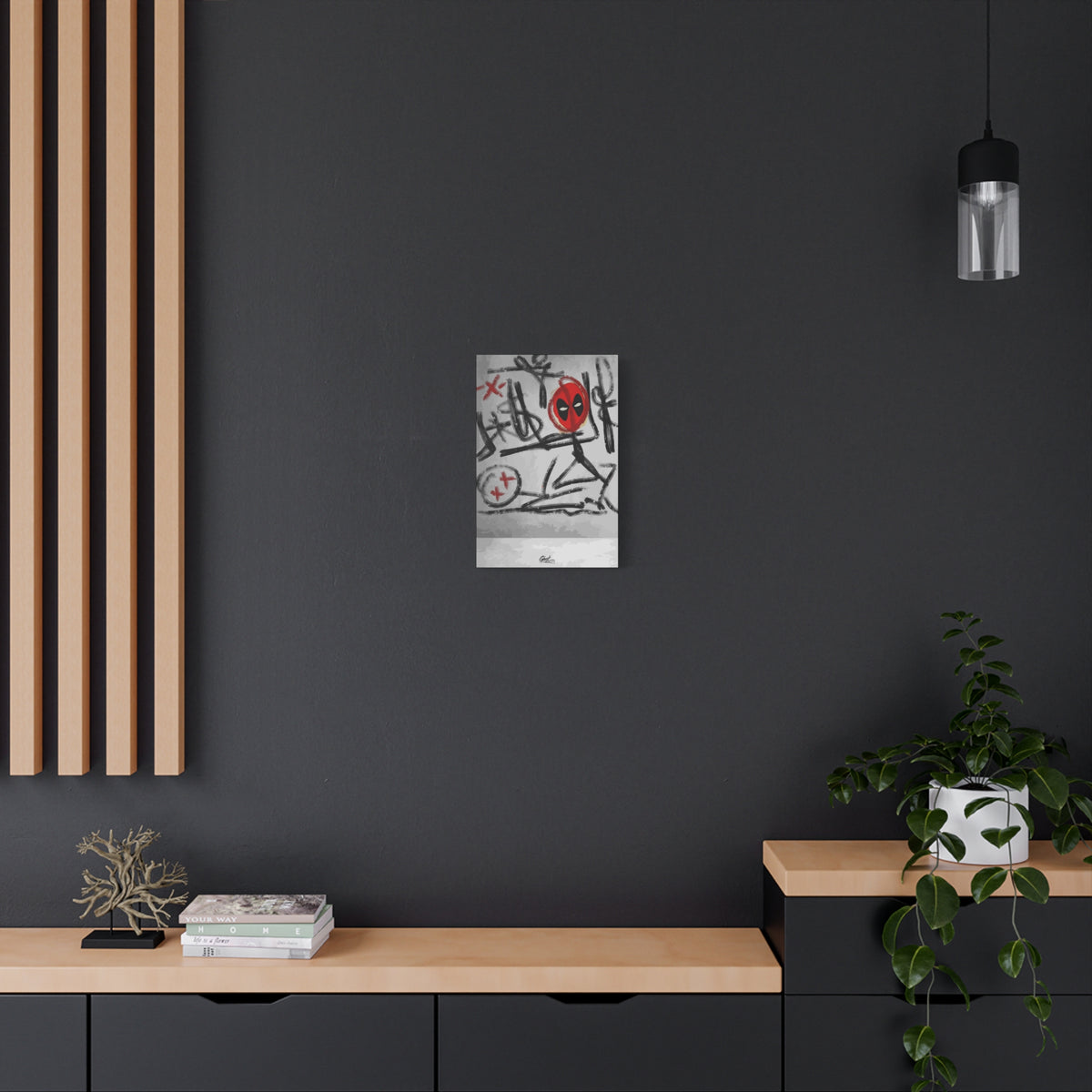 X'd Out small canvas on a charcoal wall over an oak shelf, gritty black-and-white strokes with red accents