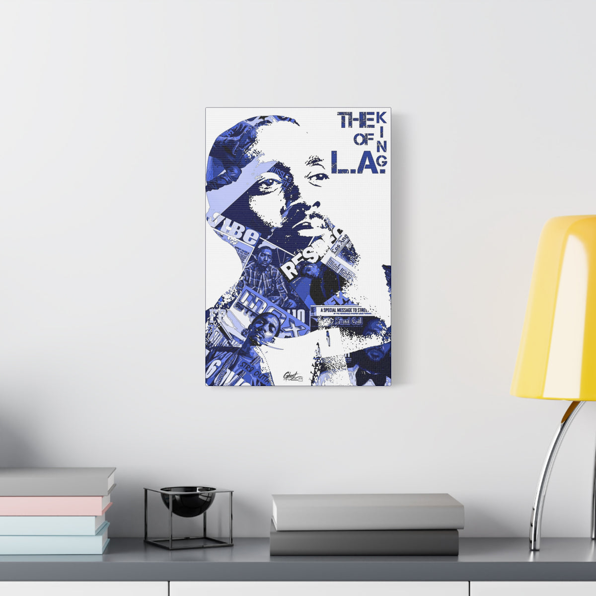 Crown of the Coast medium canvas beside a yellow desk lamp, indigo clipping-collage portrait with bold lettering