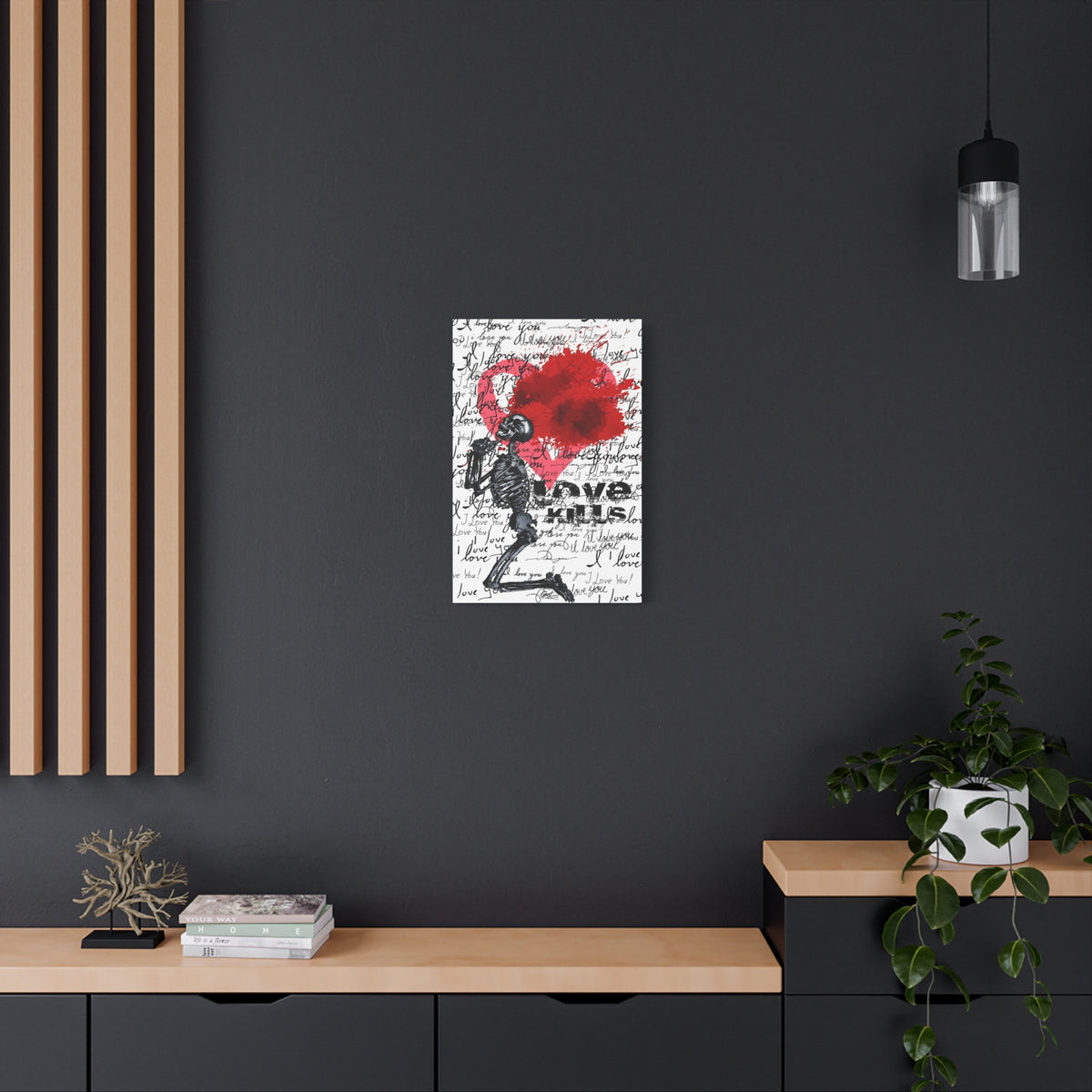Love Kills medium canvas on a charcoal wall over an oak shelf, black linework skeleton with red splatter heart