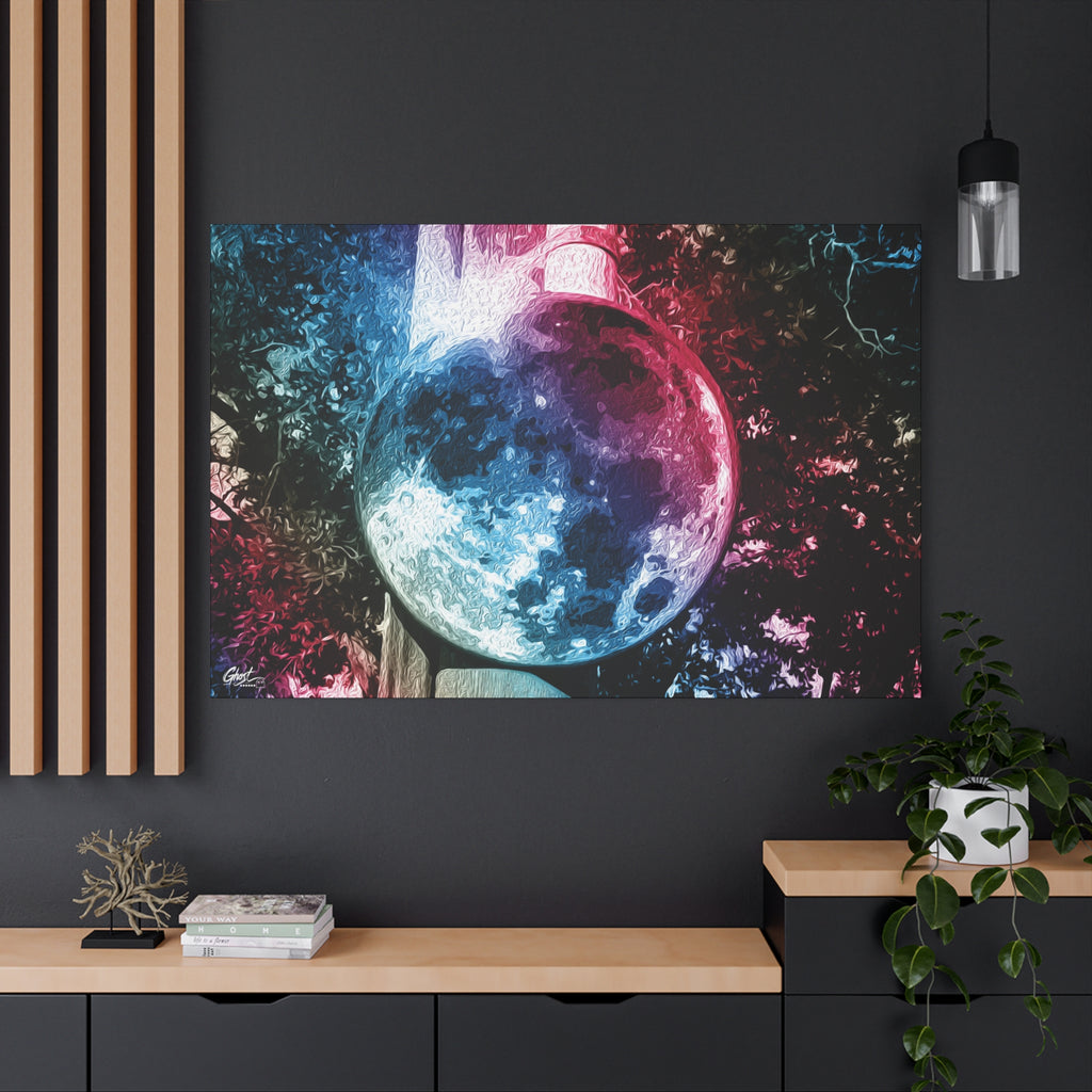 Universe in a Mirror canvas on a charcoal wall by wood slats, moon-like orb in blue and pink film tones in a surreal sky