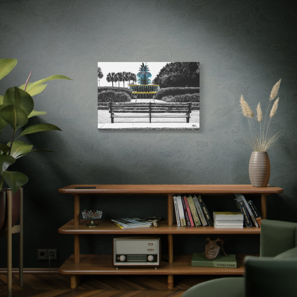 The Pineapple of Peace large canvas above a wooden bookshelf, stylized pineapple fountain with palmettos and a park bench
