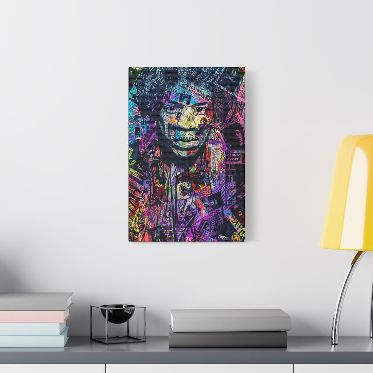 Purple Voodoo large canvas beside a yellow desk lamp, haloed face in a blue, purple and pink newspaper collage