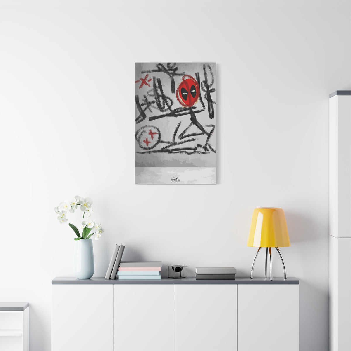 X'd Out small canvas above a white sideboard and yellow lamp, black brushstroke doodles with a red mask emblem