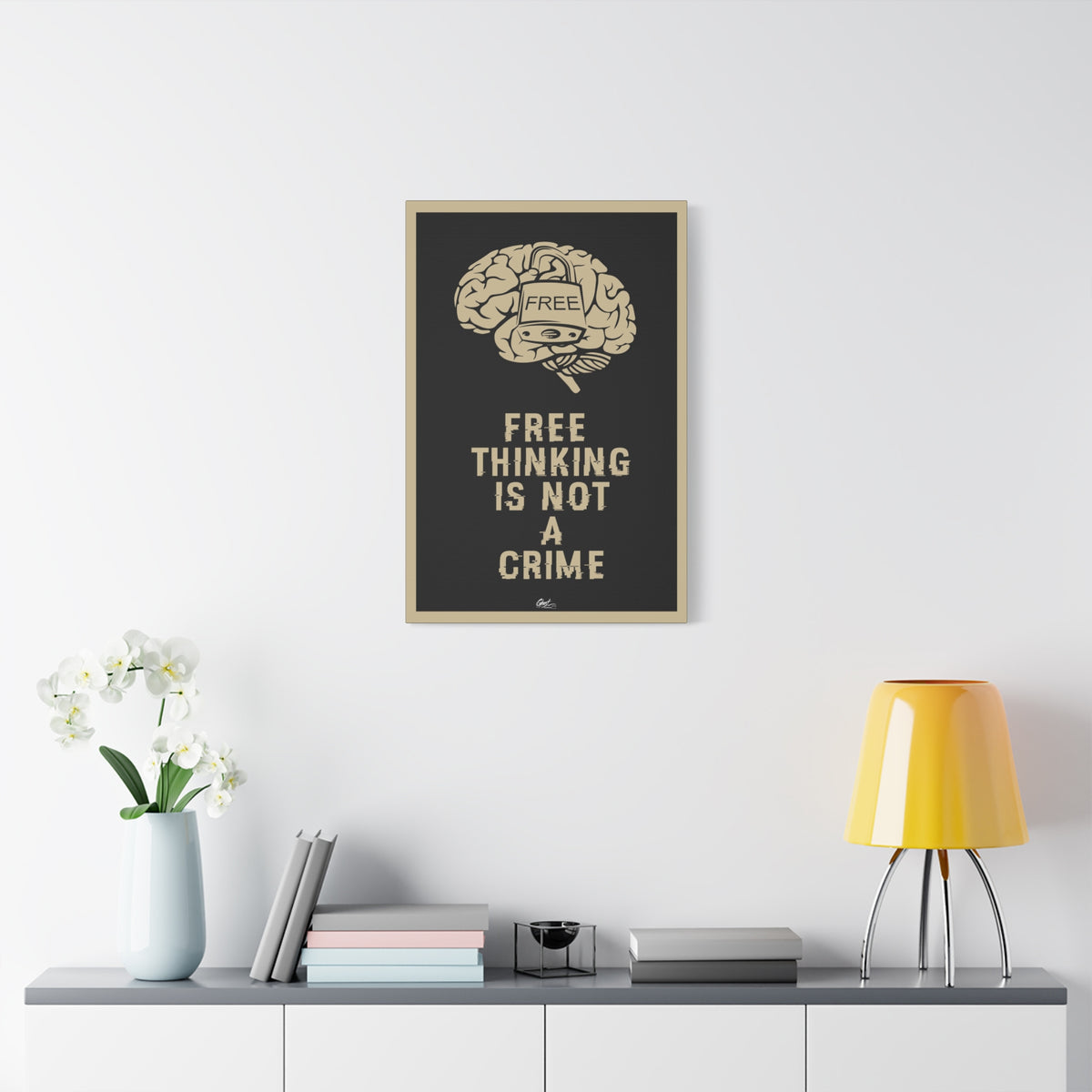 Free Thinking Is Not a Crime canvas on a white wall above a console, Free Thinking Is Not a Crime text with a padlocked brain