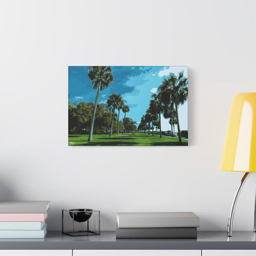 The Battery (Original) oversized canvas beside a yellow desk lamp, tall palms, green lawns and blue sky at the Battery
