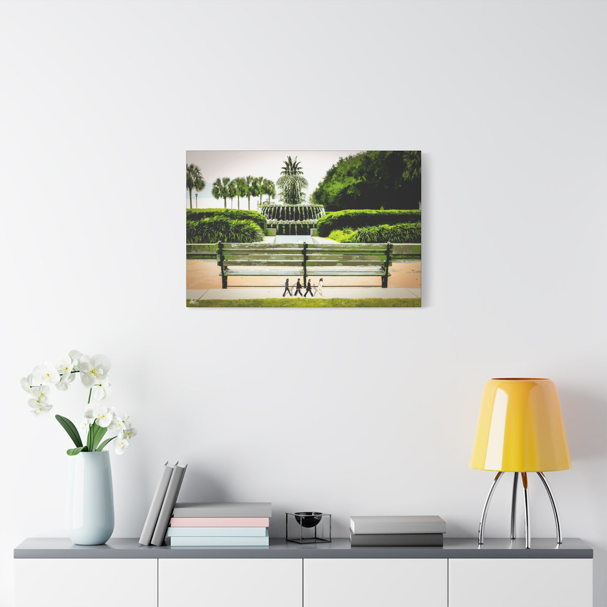 Pineapple Crossing canvas on a white wall above a console, painterly park scene with the pineapple fountain