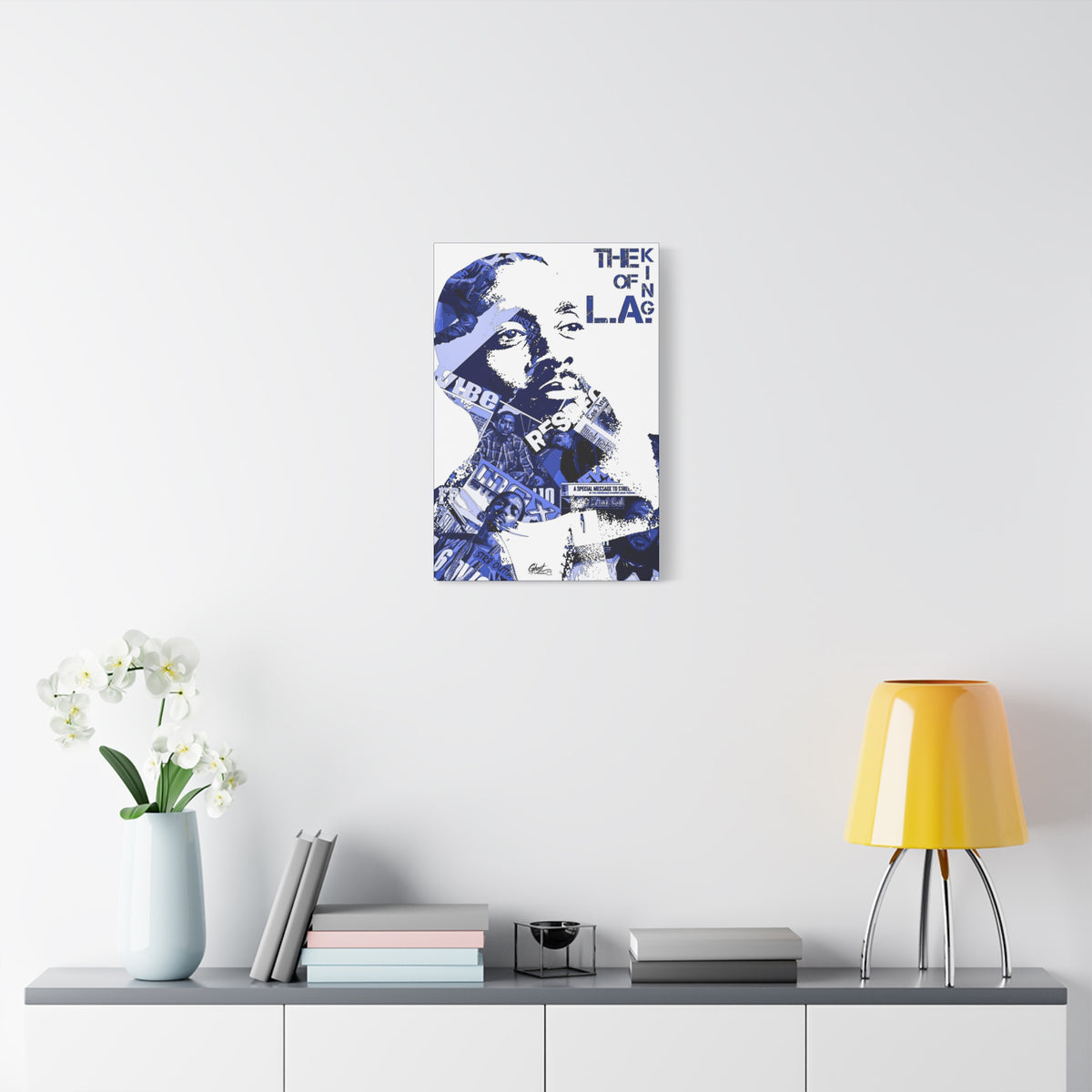 Crown of the Coast canvas over a console with white flowers, indigo clipping-collage portrait with bold lettering