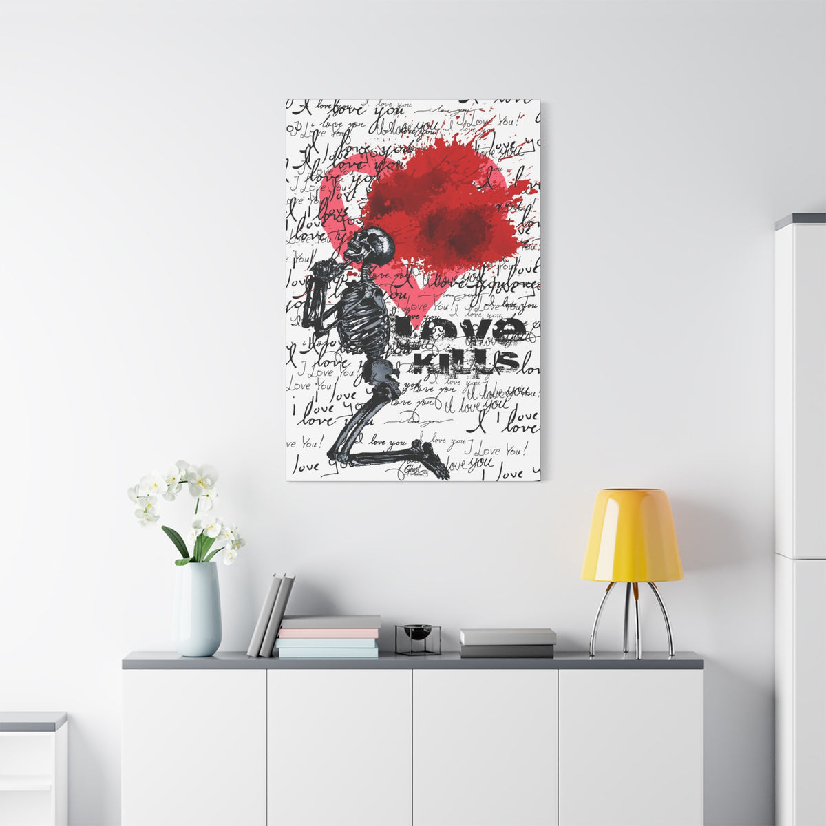 Love Kills medium canvas above a white sideboard and yellow lamp, black linework skeleton with red splatter heart