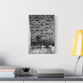 A Little Hiking in Charleston canvas beside a yellow desk lamp, stenciled hiker on a weathered brick wall in black and white