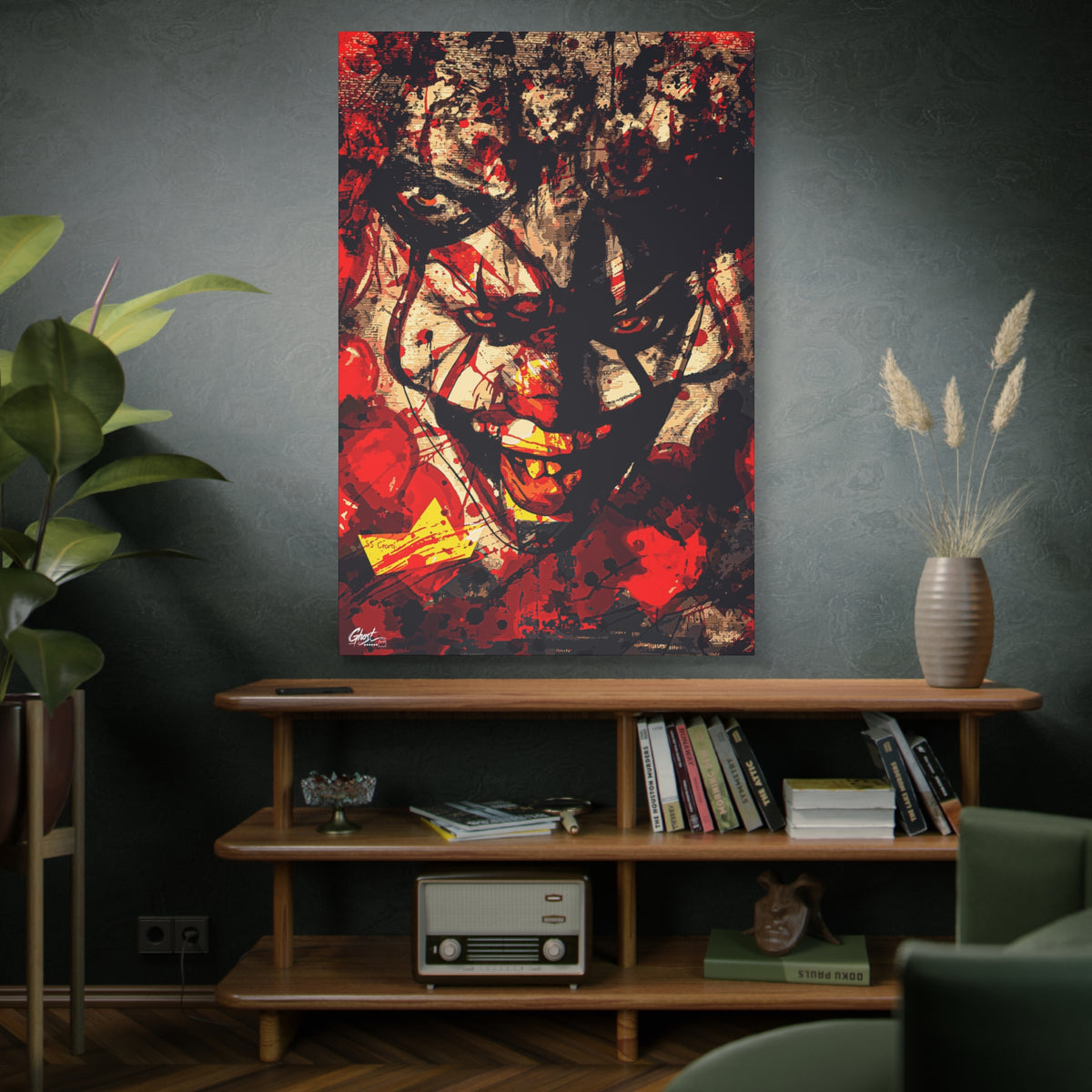 Down in a Drain large canvas above a wooden bookshelf, leering clown face in distressed red, black and cream