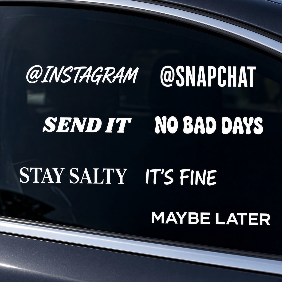Custom Signs: white vinyl window decals with social handles and fun phrases on a car window