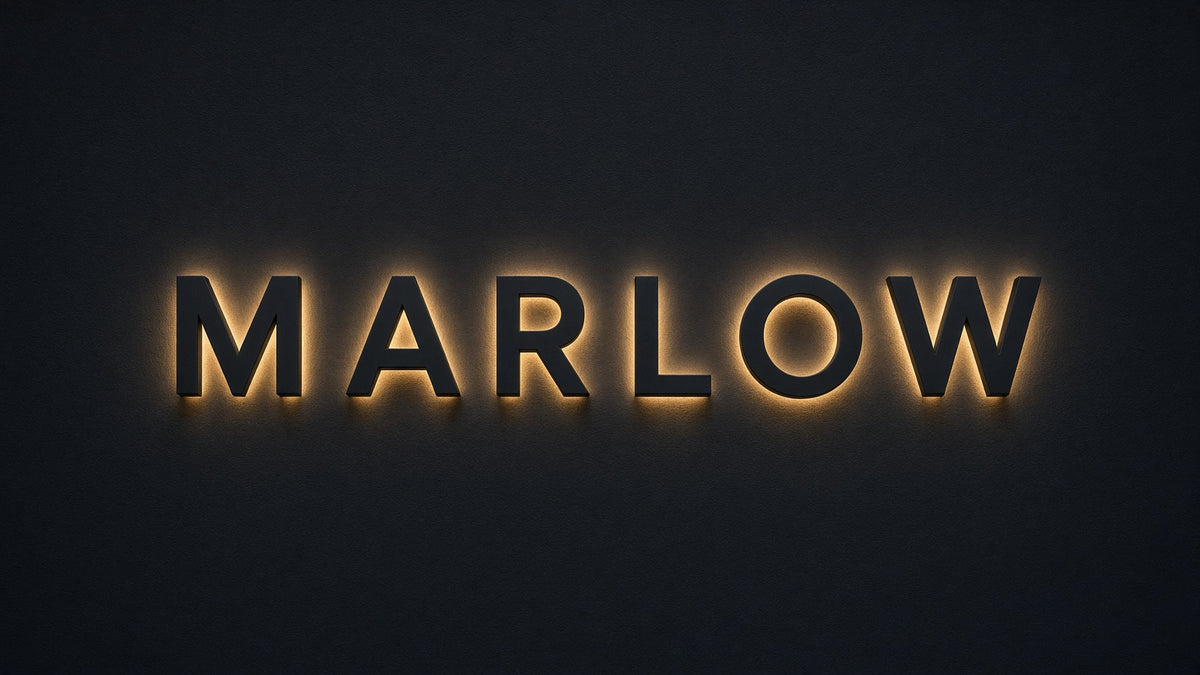 Custom Signs: backlit MARLOW halo-lit lettering on a black wall