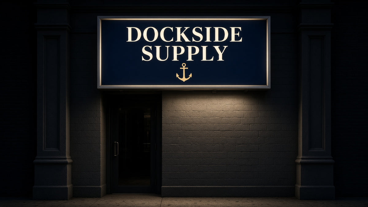 Custom Signs: DOCKSIDE SUPPLY lit sign over a dark storefront entrance